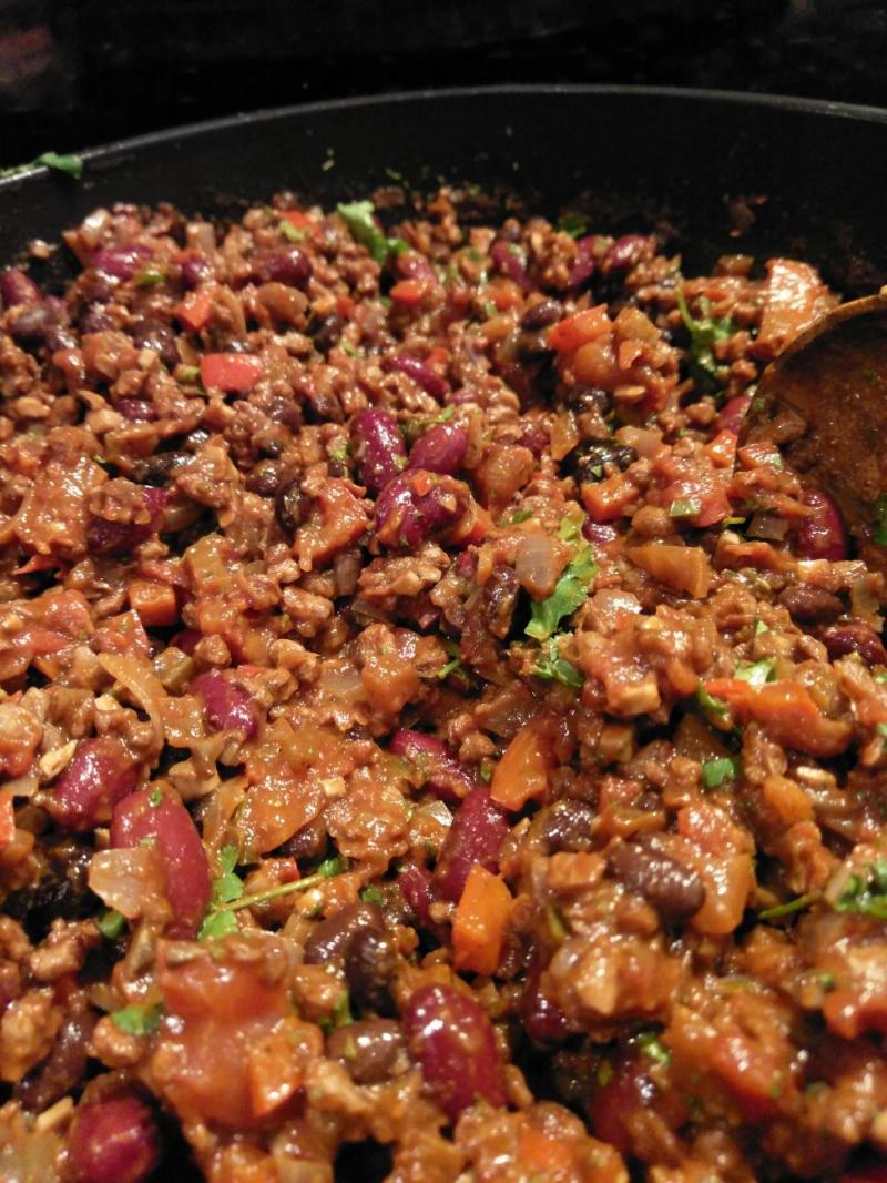 Vegan chilli "non" carne, kidney and black beans, vegetables, vegan mince in a brown, spicy sauce with some coriander