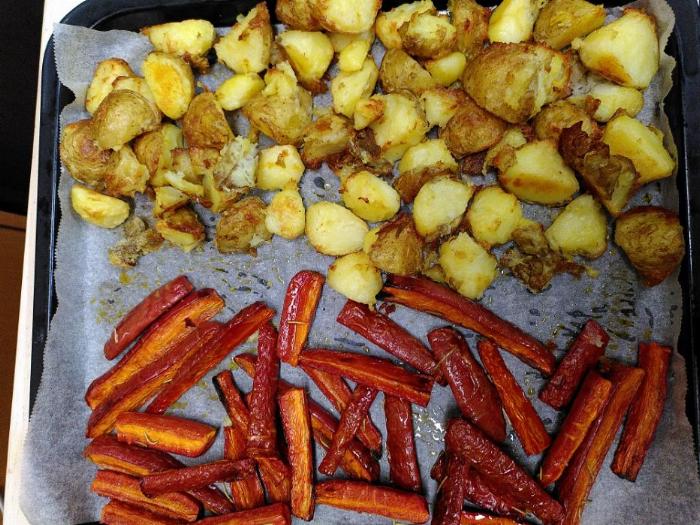 top of the picture is roasted potatoes, bottom is roasted red carrots, sharing a baking tray