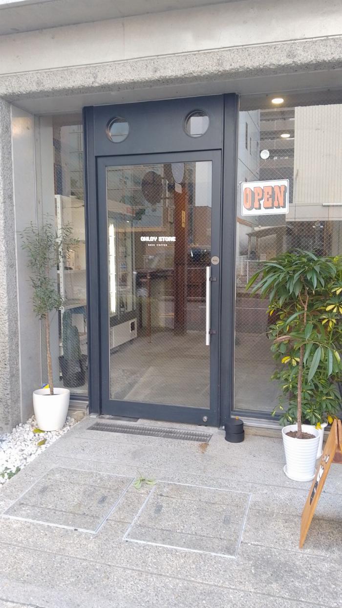 outside the Ohloy store in Takamatsu, glass door and windows with grey concrete interior.