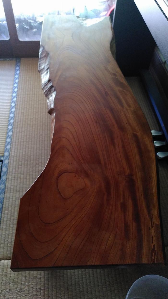 A photo of a wooden bench with the natural shape of the wood used as the seat maintained.